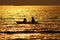 silhouette ofÂ 
Boatman rowing  in the golden sea